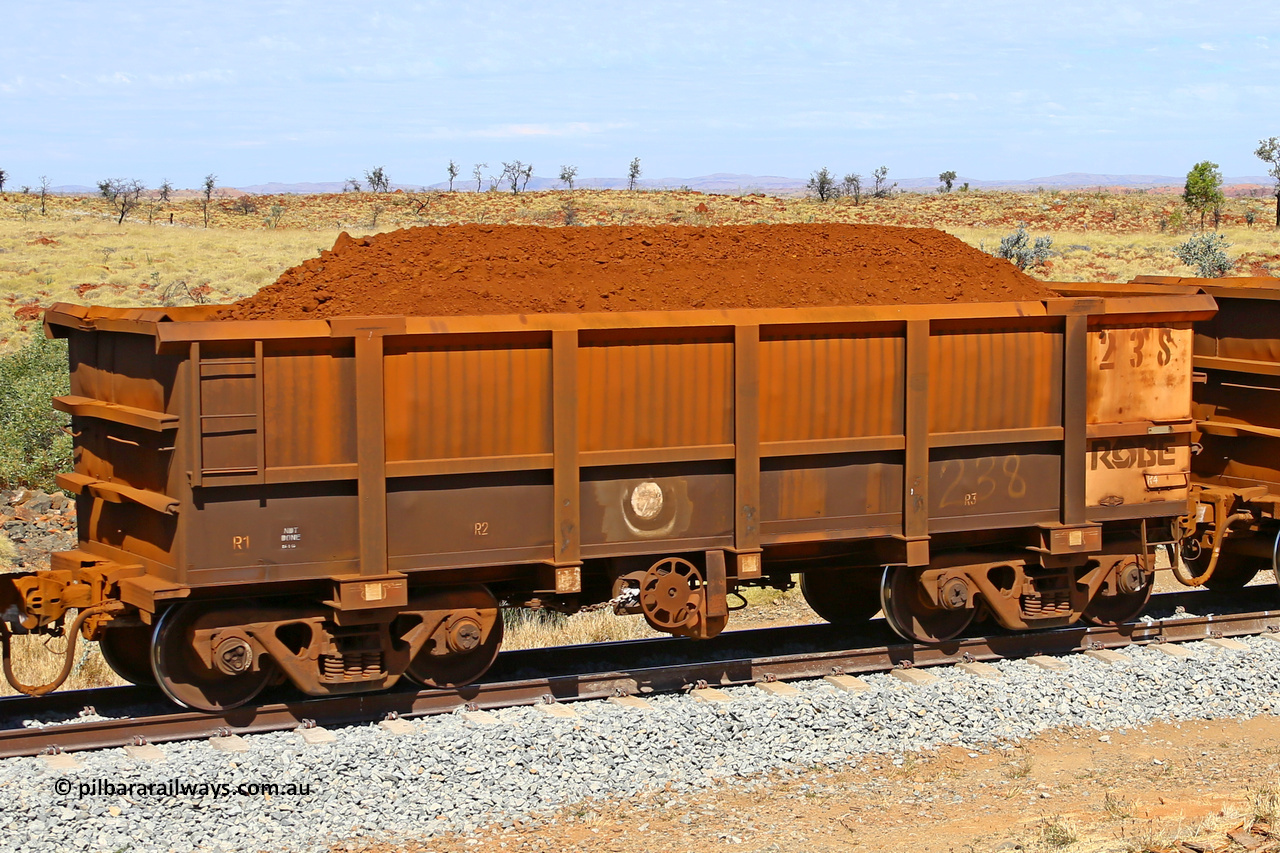 0238 170729 0252
Robe River ore waggon 238, built by Nippon Sharyo Nihon, fixed coupler handbrake side loaded view at the 103 km, between Maitland Siding and the Fortescue River on the Deepdale line. July 29, 2017.
Keywords: 238;Nippon-Sharyo-Nihon;Robe-ore-waggon;