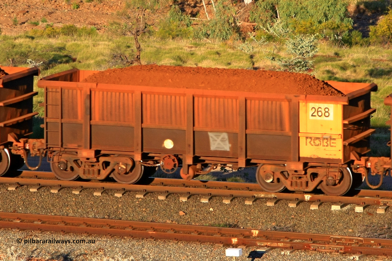 0268 110602 1620
Robe River ore waggon 268, built by Nippon Sharyo Nihon, rotary coupler end handbrake side loaded view at the 71 km, Western Creek on the Deepdale line. June 2, 2011.
Keywords: 268;Nippon-Sharyo-Nihon;Robe-ore-waggon;