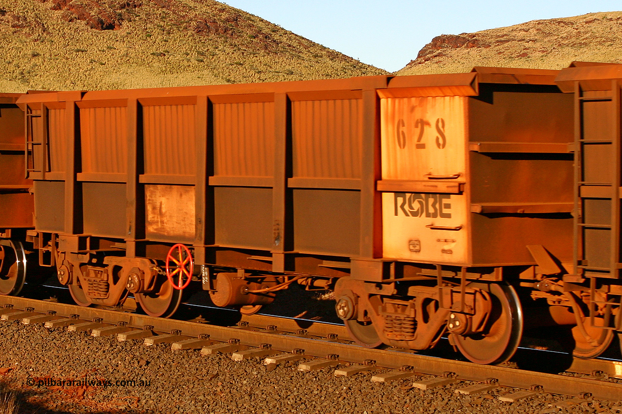 0628 060722 7604
Robe River ore waggon 628, built by Tomlinson Steel WA, rotary coupler end handbrake side empty view, at the 11.7 km, Cape Lambert. July 22, 2006.
Keywords: 628;Tomlinson-Steel-WA;Robe-ore-waggon;