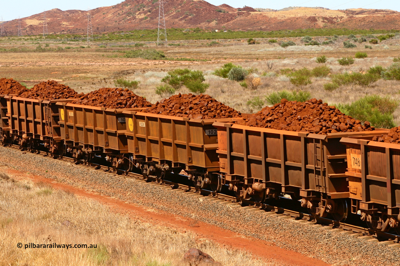 0711 061209 8187
Robe River ore waggon 711, built by Tomlinson Steel WA, fixed coupler non-handbrake side loaded view, along with two new Bradken builds, at the 7 km location just south of Cape Lambert yard. December 9, 2006.
Keywords: 711;Tomlinson-Steel-WA;Robe-ore-waggon;