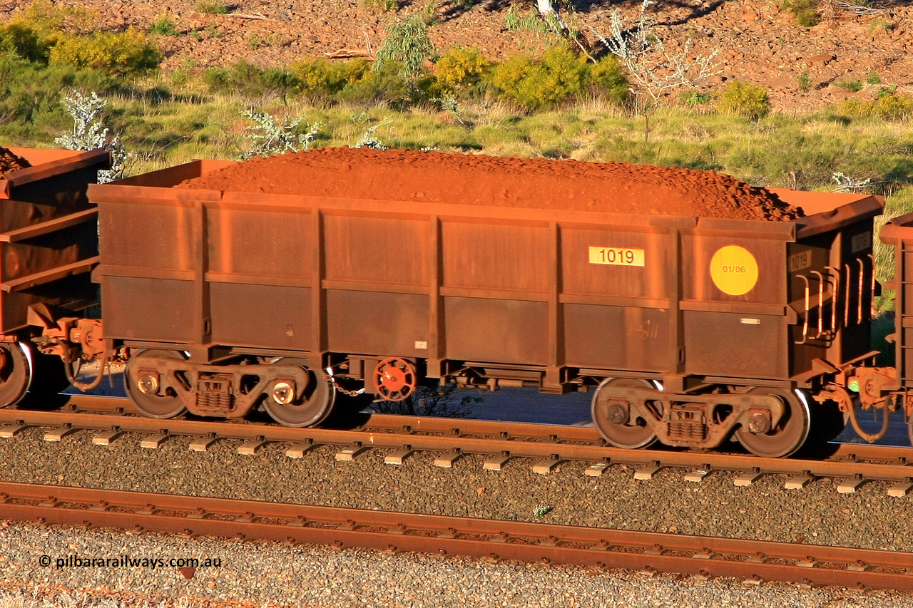 1019 110602 1702
Robe River ore waggon 1019, built by Bradken Rail Qld in January 2006, rotary coupler end handbrake side loaded view at the 71 km, Western Creek on the Deepdale line. June 2, 2011.
Keywords: 1019;Bradken-Rail-Qld;Robe-ore-waggon;