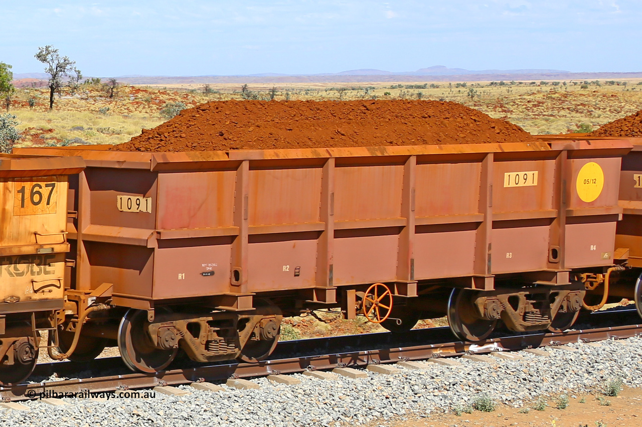 1091 170729 0214
Robe River ore waggon 1091, built by Bradken Rail Qld in May 2012, fixed coupler handbrake side loaded view at the 103 km, between Maitland Siding and the Fortescue River on the Deepdale line. July 29, 2017.
Keywords: 1091;Bradken-Rail-Qld;Robe-ore-waggon;