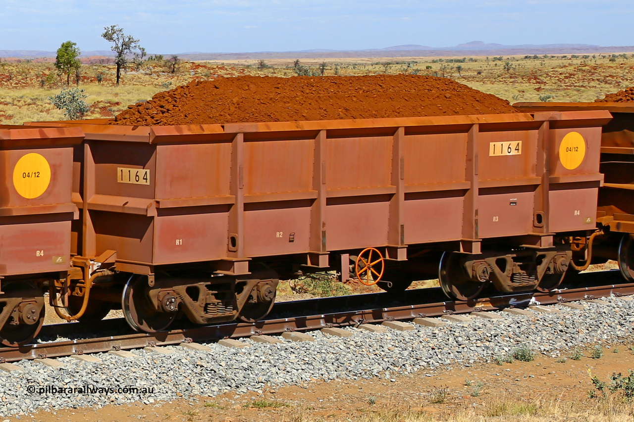 1164 170729 0263
Robe River ore waggon 1164, built by Bradken Rail Qld in April 2012, fixed coupler handbrake side loaded view at the 103 km, between Maitland Siding and the Fortescue River on the Deepdale line. July 29, 2017.
Keywords: 1164;Bradken-Rail-Qld;Robe-ore-waggon;