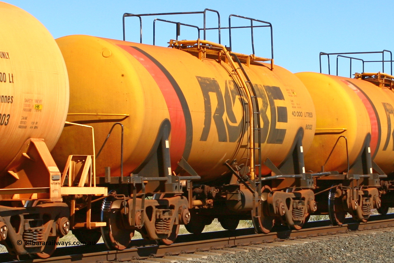 8002 060716 7200
Robe River diesel fuel tank waggon 8002 running empty on the rear of a loaded ore train, built by Comeng NSW in September 1972 with a 45,000 litre capacity, at the 71 km on the Deepdale line, Western Creek, July 16, 2006.
Keywords: 8002;Comeng-NSW;Robe-tank-waggon;
