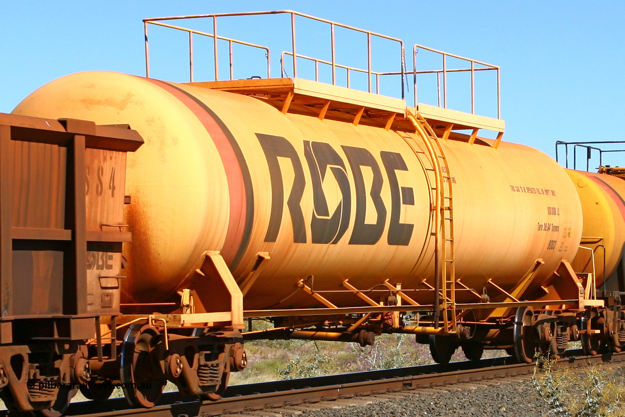 8003 060716 7199
Robe River diesel fuel tank waggon 8003 running empty on the rear of a loaded ore train, built by Comeng NSW in March 1979 with a 100,000 litre capacity, at the 71 km on the Deepdale line, Western Creek, July 16, 2006.
Keywords: 8003;Comeng-NSW;Robe-tank-waggon;
