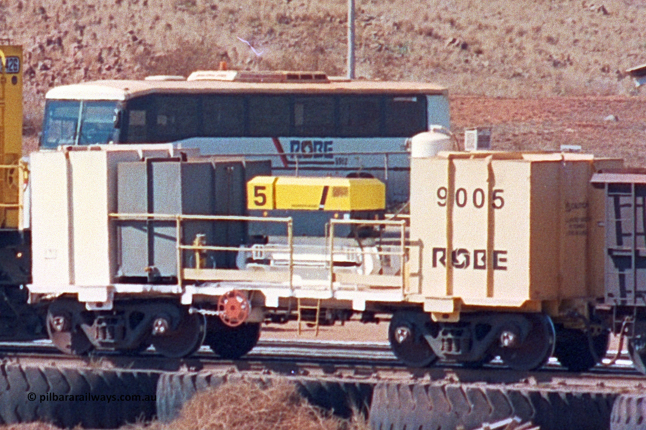 9005 020522 247 03
Robe River compressor waggon 9005, a modified Nippon Sharyo Nihon built waggon with air compressor, grey fuel tank and white air receiver. This style of compressor setup differs greatly from the original compressor waggons built by Nippon Sharyo Nihon. Cape Lambert yard May 22, 2002.
Keywords: 9005;robe-compressor-waggon;
