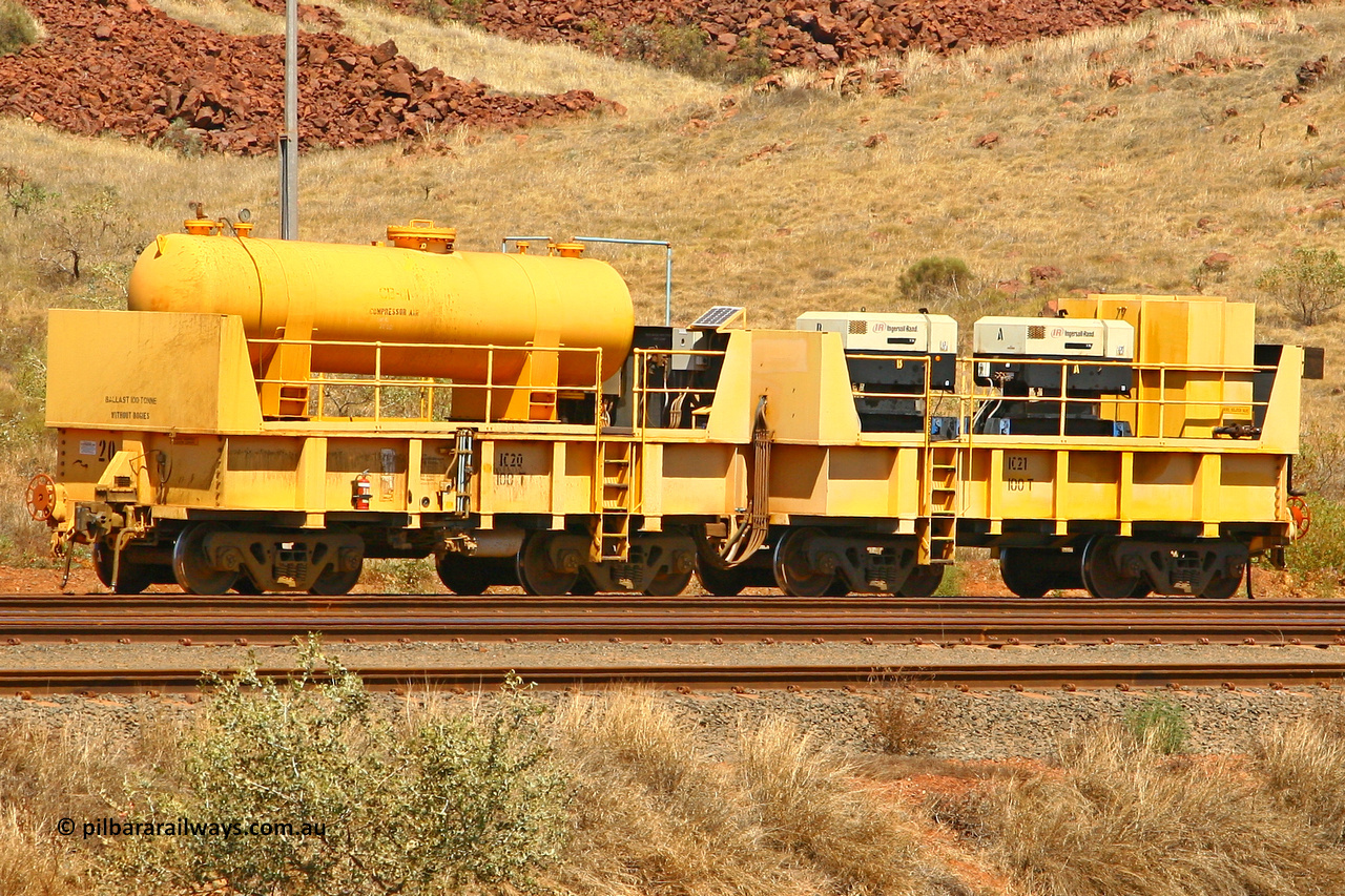 IC20 070908 0596
Robe River compressor waggon set IC 20 with air receiver and IC 21 with two Ingersoll Rand air compressors. These waggons are ballasted to 100 tonnes each and are modified ore waggons and used on the pooled fleet rakes that come from HIY [Yandicoogina] and West Angelas mines. Cape Lambert yard August 8, 2007.
Keywords: IC20;IC21;robe-compressor-waggon;