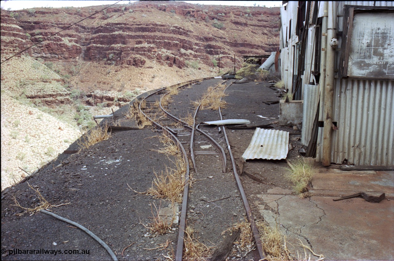 194-10
Wittenoom Gorge, Colonial Mine, asbestos mining remains, view looking south past the underground mining and railway offices with the track running towards the workshops.
