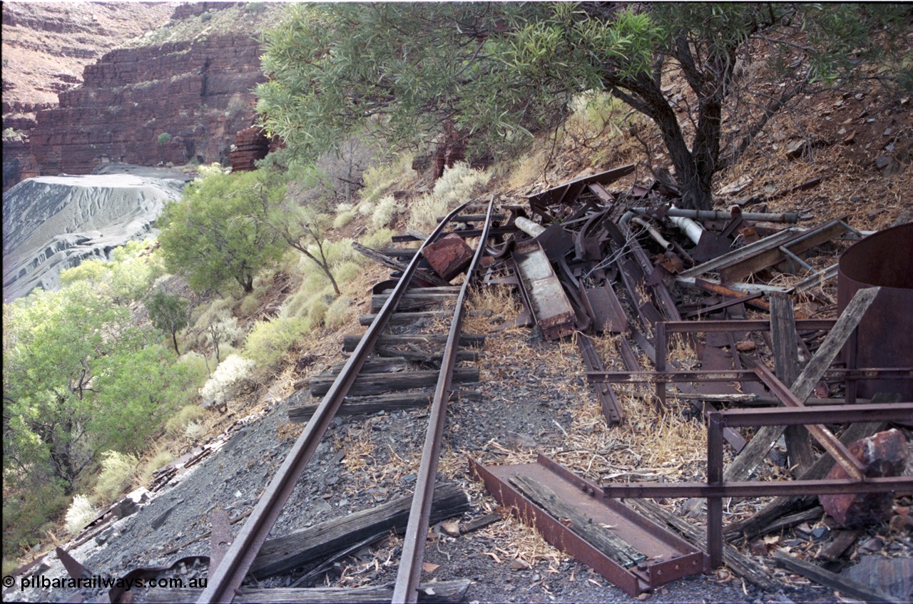 194-14
Wittenoom Gorge, Colonial Mine, asbestos mining remains, view looking sort of south west past scrap steel, tailings pile, track used to go around corner to other mine adits.
