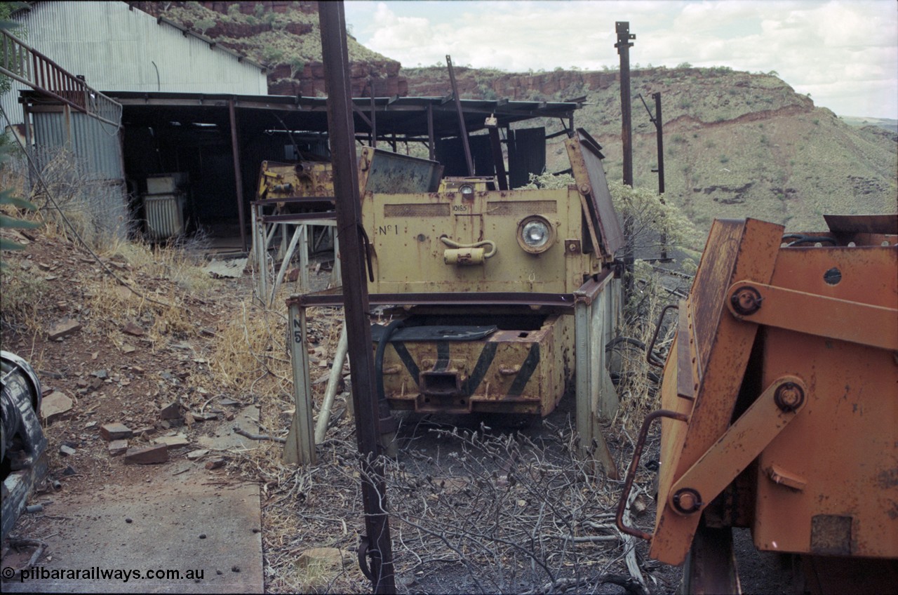 194-17
Wittenoom Gorge, Colonial Mine, asbestos mining remains, view of railway workshop - battery charging plant looking north, Gemco unit at right, English Electric unit with No. 1 battery in front. Catwalk visible in distance.

