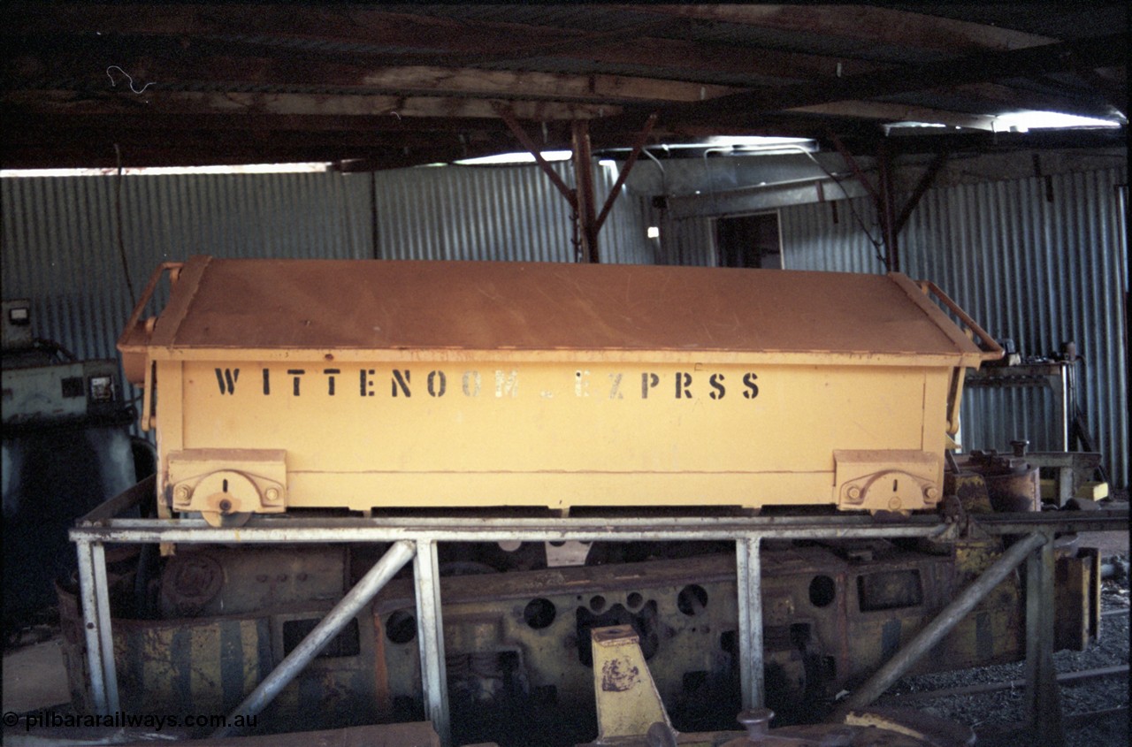 194-20
Wittenoom Gorge, Colonial Mine, asbestos mining remains, battery module over a Mancha hauler, titled WITTENOOM_EXPRSS inside the workshops. This item was relocated to the Pilbara Railways Historical Society museum near 7 Mile Karratha in 2004.
