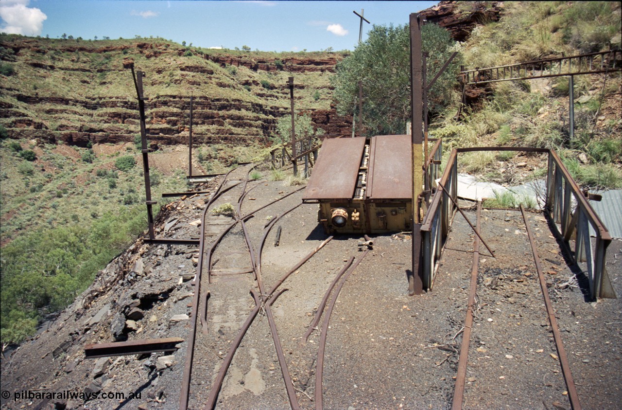 197-12
Wittenoom, Colonial Mine, asbestos mining remains, view looking south of the battery charging shed remains, battery off-take ramps and a battery module are visible along with the shed posts.
