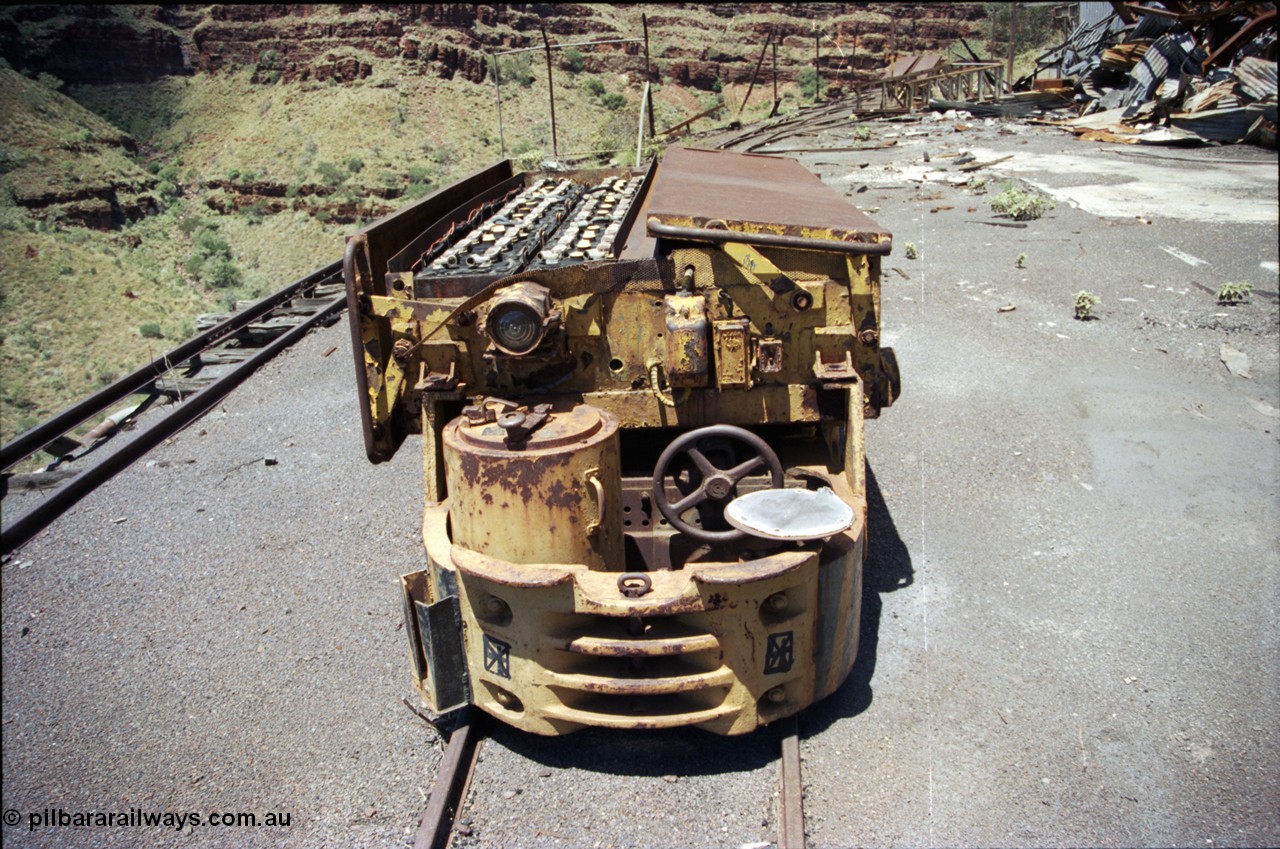 197-15
Wittenoom, Colonial Mine, asbestos mining remains, Mancha battery locomotive #4 looking south east, demolished workshops and office on the right with the battery charging shed remains in the distance. Drivers seat, brake wheel and controller.
Keywords: Mancha;