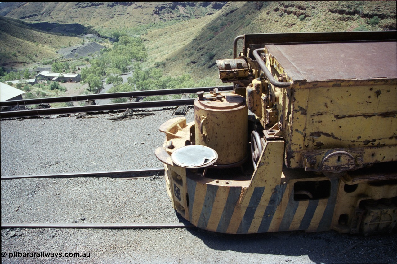 197-17
Wittenoom, Colonial Mine, asbestos mining remains, view looking across the drivers seat of Mancha battery locomotive #4 down the gorge towards Joffre Creek with the workshops building in the distance and some air under the dump track.
Keywords: Mancha;