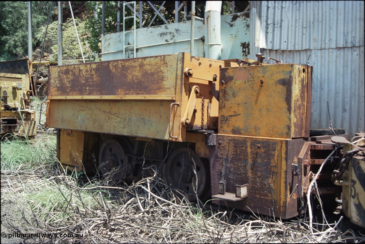 198-05
Wittenoom, Colonial Mine, asbestos mining remains, front view of throttle control box, battery box and wheel and brake arrangement of battery locomotive GEMCO Hauler serial 12304-05/10/65, motor H.P. 2/11, volts 80, drawbar pull (lbs.) 1250 built by George Moss Pty Ltd Leederville, WA.
Keywords: Gemco;George-Moss;12304-05/10/65;