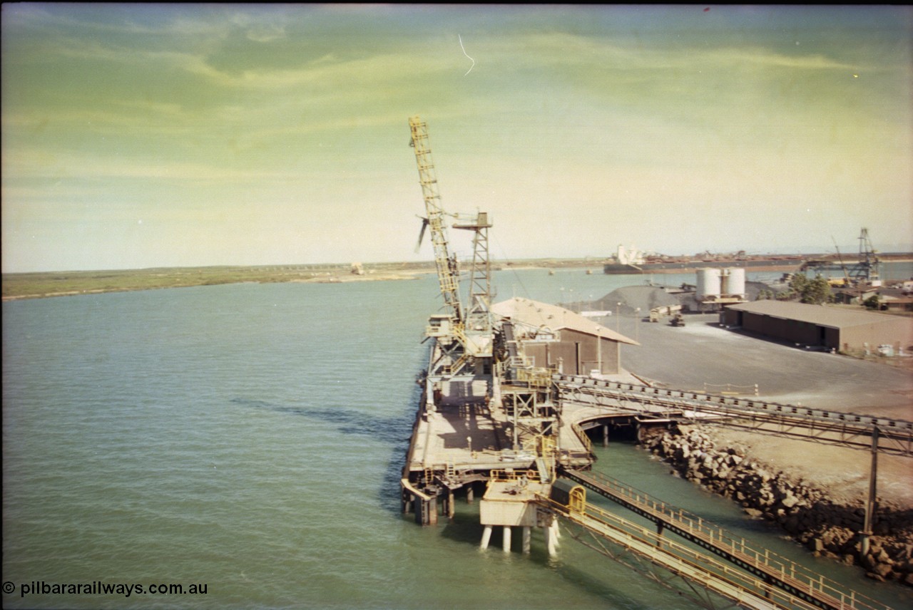 198-20
Port Hedland Port, view of the Cargill Salt berth and loader, or PHPA Berth No. 3, in this 2001 view, the then new bulker loader is under construction and manganese is stockpiled on the ground. The BHP Finucane Island berth is visible along with the overland conveyor for the HBI plant.
