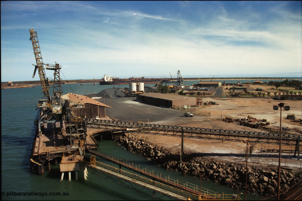 198-22
Port Hedland Port, view of the Cargill Salt berth and loader, or PHPA Berth No. 3, in this 2001 view, the then new bulker loader is under construction and manganese is stockpiled on the ground. The BHP Finucane Island berth is visible along with the overland conveyor for the HBI plant, in the far background is the admin building for BHP Transport the operator of the Tug Boats.
