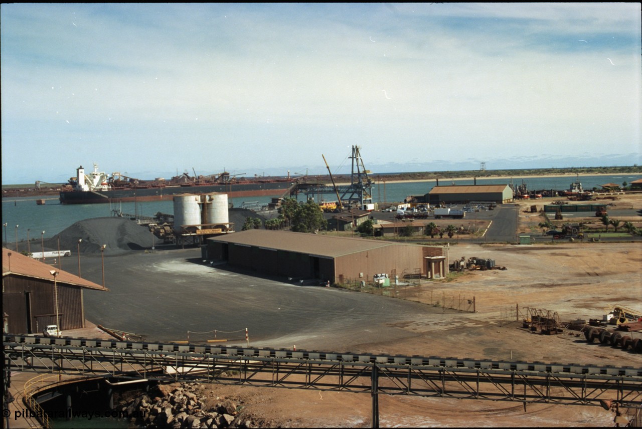 198-23
Port Hedland Port, view of the hard stand and overview of the PHPA, manganese is stockpiled around the former Cockburn Cement silos, new bulk loader under construction, tug pen visible along with single berth at BHP Finucane Island.
