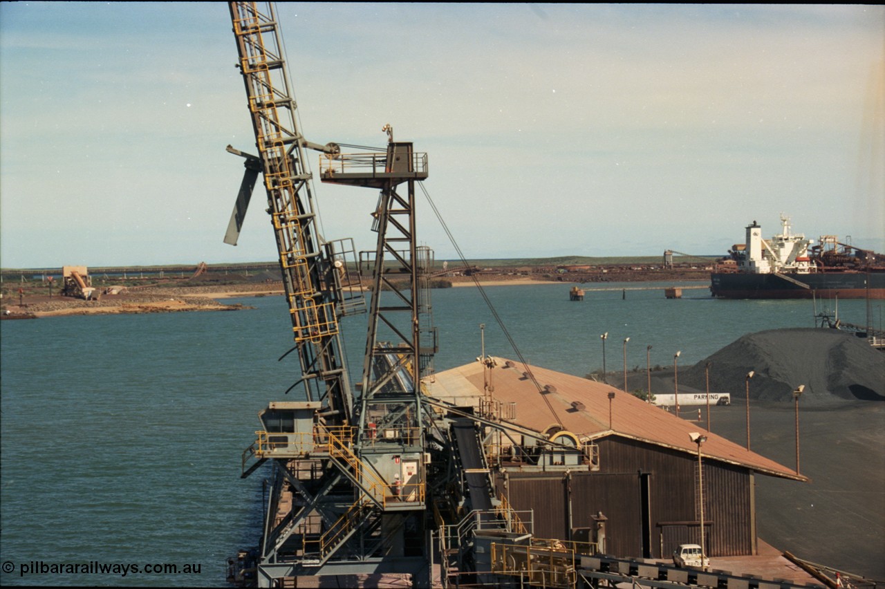 198-29
Port Hedland Port, view of Cargill Salt loader on No. 3 Berth, BHP under-harbour tunnel portal and overland conveyor for HBI plant visible along with Finucane Island, 2001.
