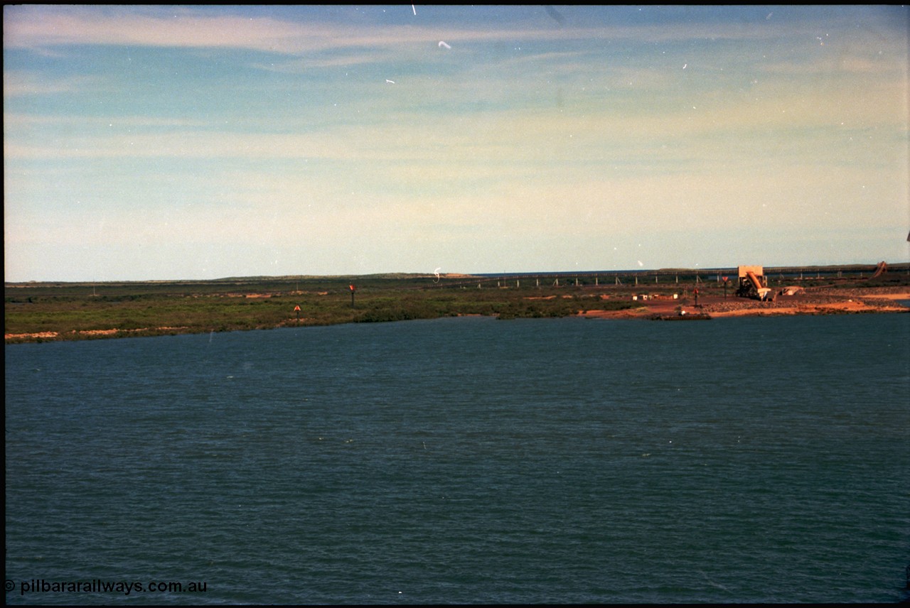 198-30
Port Hedland Port, view of the BHP HBI plant overland conveyor and under-harbour tunnel portal, also Utah Point Boat Ramp. This area is now changed with Pilbara Ports Authority No.4 Berth, and three additional berths for BHP Billiton. Images taken 2001.

