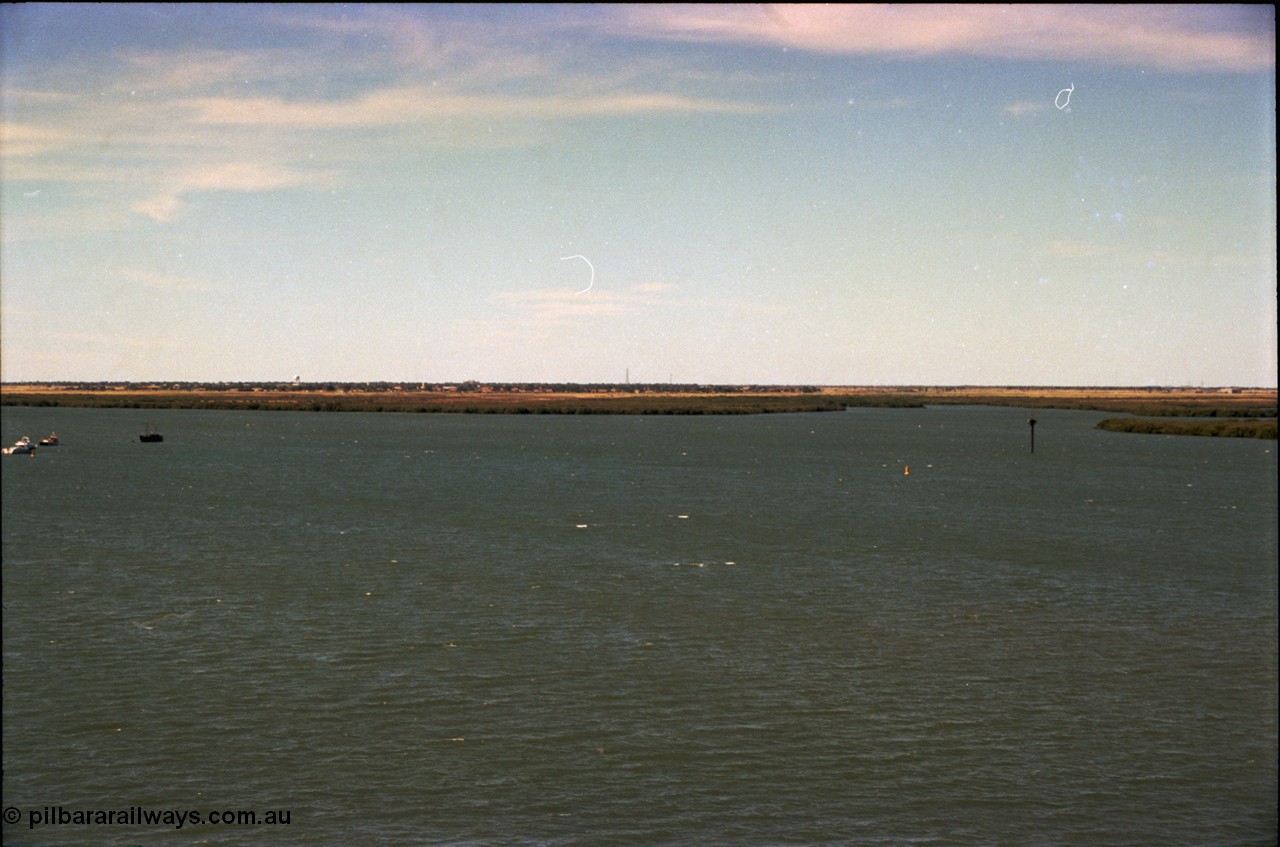 198-32
Port Hedland Port, view of ship turning basin with the South Hedland water tank in the distance, FMG now have a three berths in this location on the right. Early 2001.
