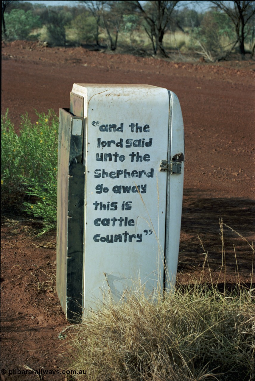 205-04
Hooley Station front gate, old refrigerator used for mailbox, 'and the lord said unto the Shepard go away this is cattle country'.
