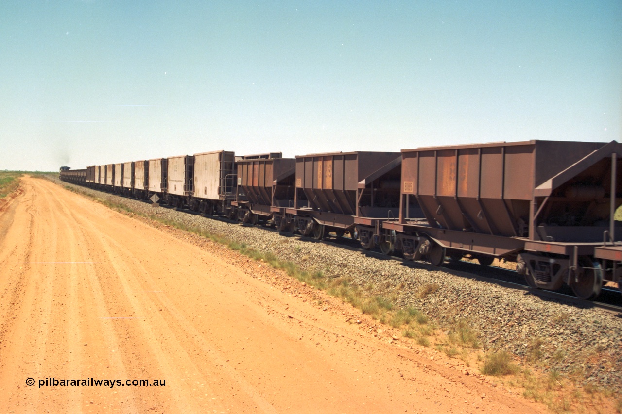 206-33
An empty train on the Yarrie (former Goldsworthy) line with a string of Golynx ore waggons, built by Goninan WA to a Lynx Engineering design, and then the two types of the waggons from the Phelps Dodge Copper Mine, the ribbed units are built by Portec USA and the smooth ones built by Gunderson USA and finally the Tomlinson Steel WA built hopper waggons. All of these are belly dump waggons as opposed to the BHP fleet of rotary dump bodies.
Keywords: 8185;Tomlinson-Steel-WA;BHP-ore-waggon;