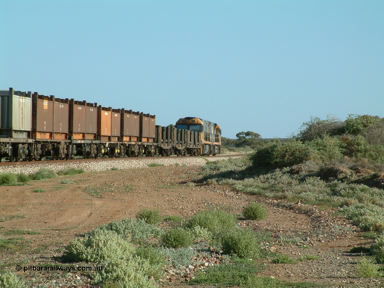 030404 082831
Port Germein, Perth bound steel and intermodal hurries through on the main behind National Rail's Goninan built GE Cv40-9i model NR class units NR 30 serial 7250-06 / 97-236 and a sister unit. 4th April 2003.
