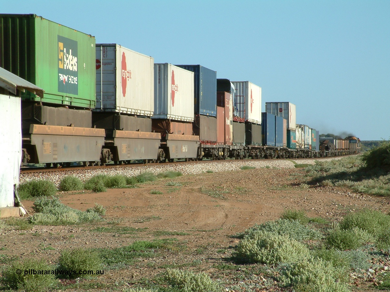 030404 082851
Port Germein, Perth bound steel and intermodal hurries through on the main behind National Rail's NR class units, showing one and a half stacking. 4th April 2003.
