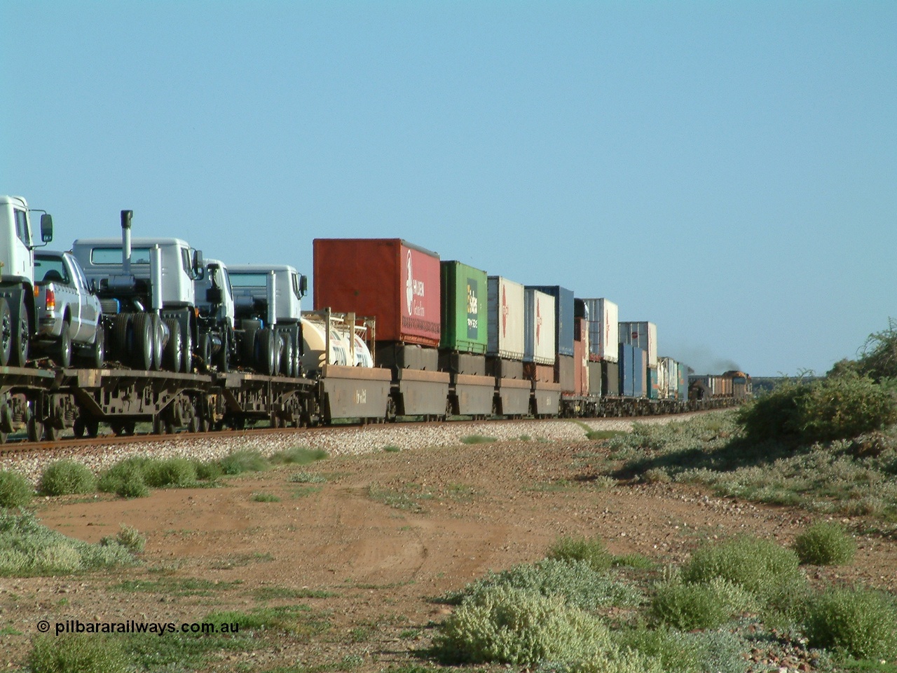 030404 082858
Port Germein, Perth bound steel and intermodal hurries through on the main behind National Rail's NR class units, showing one and a half stacking and new vehicles on flat waggons. 4th April 2003.
