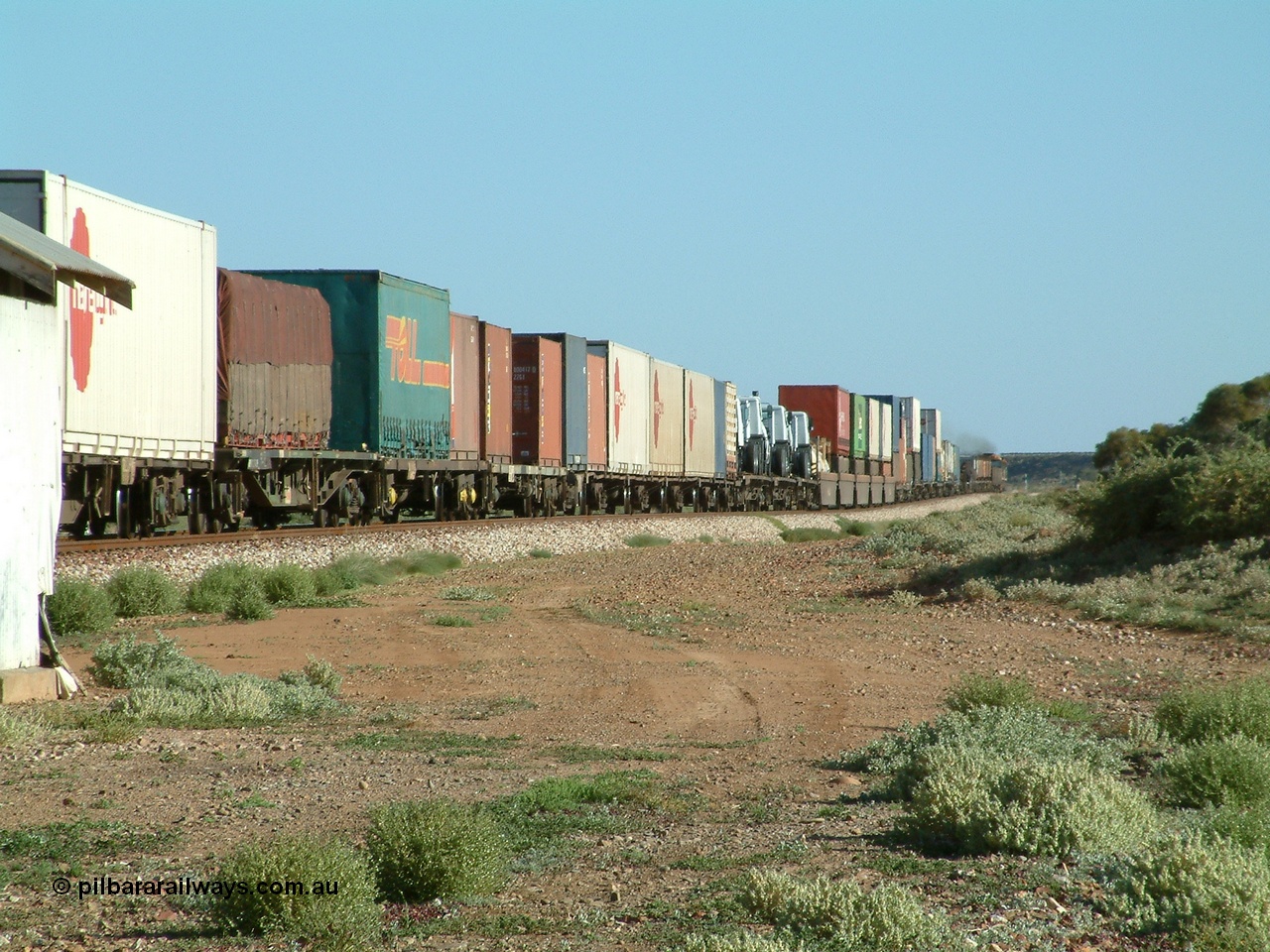 030404 082909
Port Germein, Perth bound steel and intermodal hurries through on the main behind National Rail's NR class units, showing one and a half stacking and new vehicles on flat waggons. 4th April 2003.

