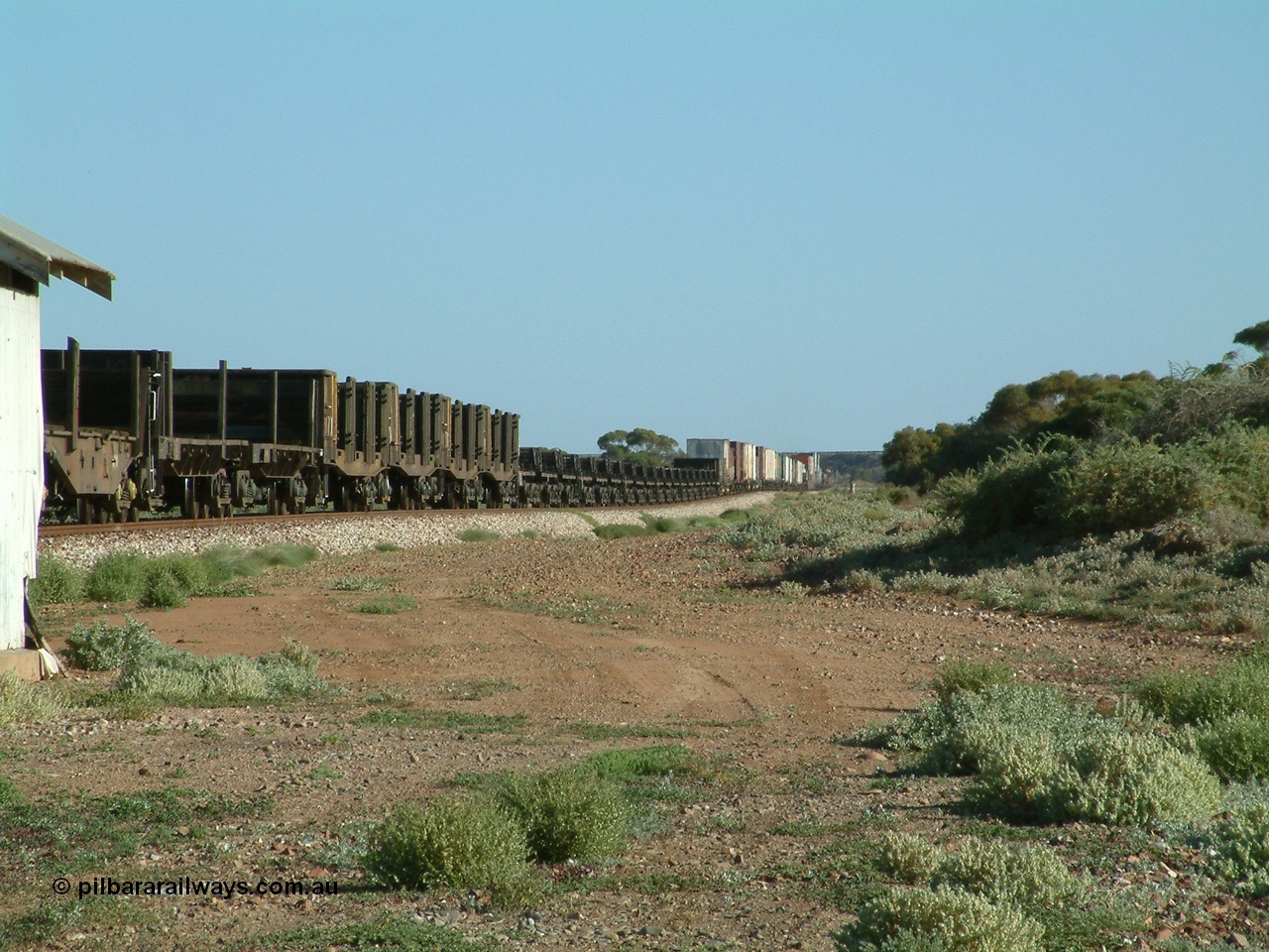 030404 083001
Port Germein, Perth bound steel and intermodal hurries through on the main with empty steel loading on the rear. 4th April 2003.
