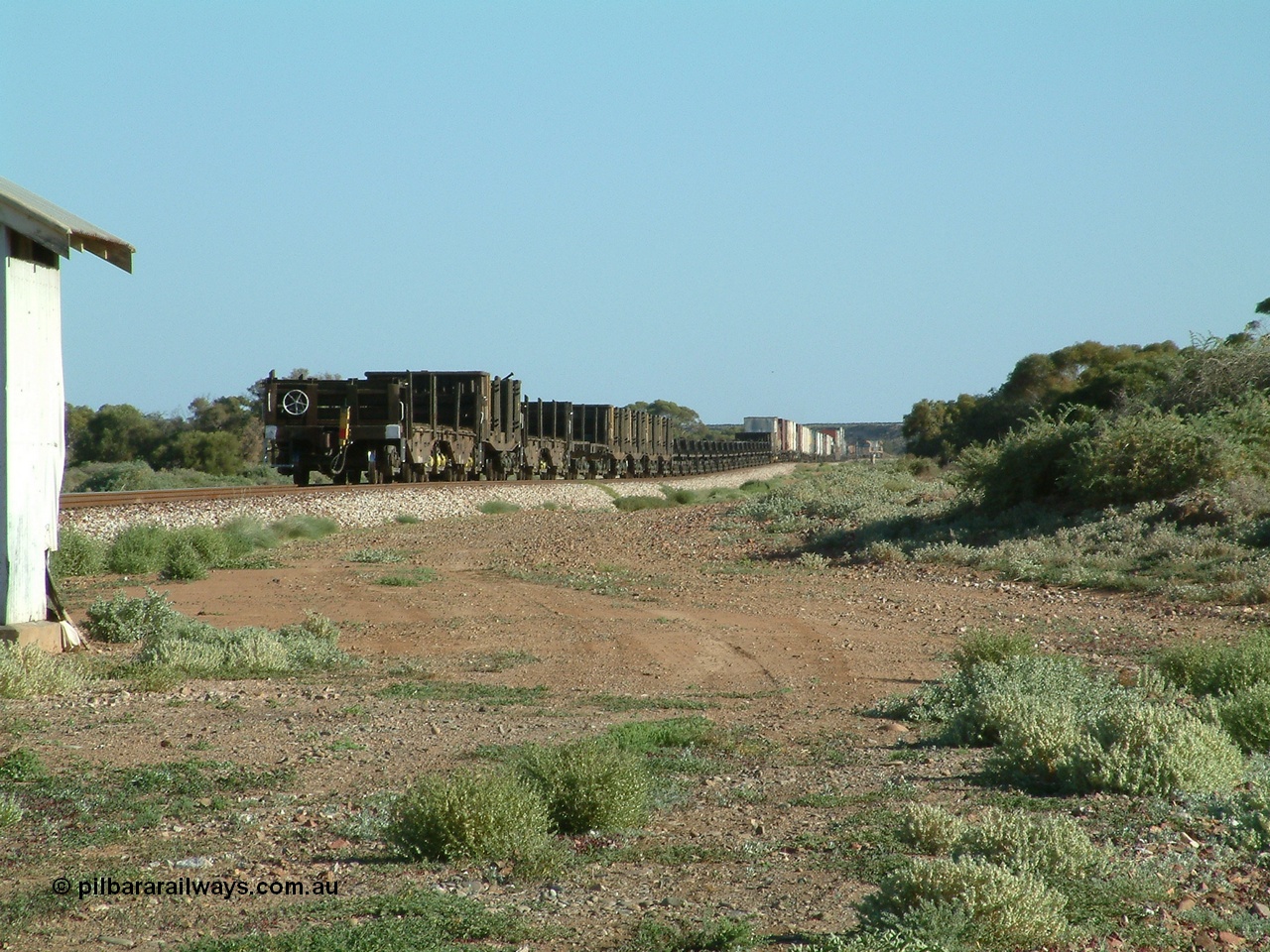 030404 083008
Port Germein, Perth bound steel and intermodal hurries through on the main with empty steel loading on the rear. 4th April 2003.
