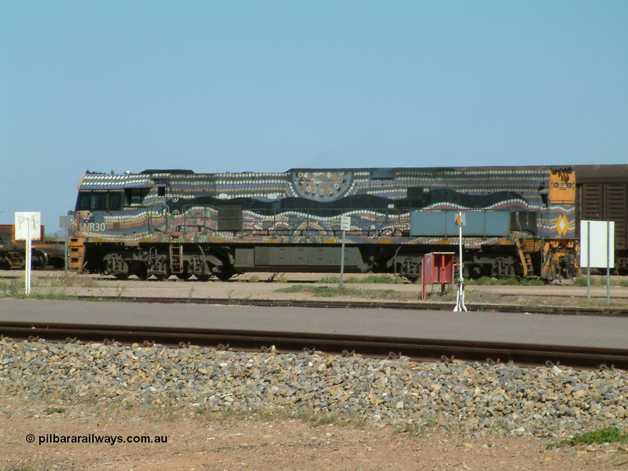 030404 103013
Port Augusta, Goninan built GE model Cv40-9i NR class unit NR 30 serial 7250-05 / 97-232 was painted in a Bessie Liddle of Alice Springs designed aboriginal livery titled 'Warmi' or the snake, John Moriarty of Balarinji Design did the artwork.
Keywords: NR-class;NR30;Goninan;GE;Cv40-9i;7250-05/97-232;