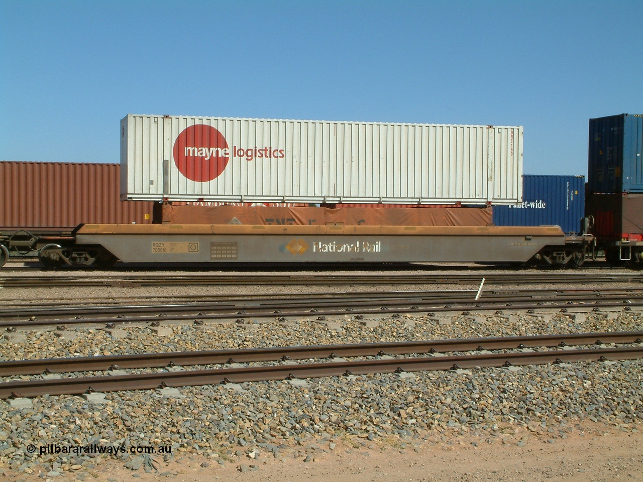 030404 104443
Port Augusta, Spencer Junction yard, RQZY type five unit bar coupled well container waggon RQZY 7050 built as one of a batch of thirty two by Goninan NSW for National Rail, with a Mayne Logistics 48' box DRC 180 on top of a TNT tarped 40' half height unit. 4th April, 2003.
Keywords: RQZY-type;RQZY7050;Goninan-NSW;1995-96/32-16;