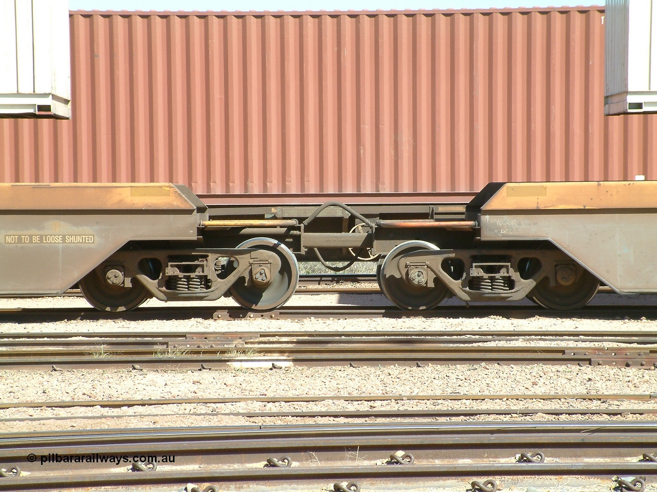 030404 104454
Port Augusta, Spencer Junction yard, RQZY type five unit bar coupled well container waggon RQZY 7050 built as one of a batch of thirty two by Goninan NSW for National Rail, detail of the bar coupling arrangement. 4th April, 2003.
Keywords: RQZY-type;RQZY7050;Goninan-NSW;1995-96/32-16;