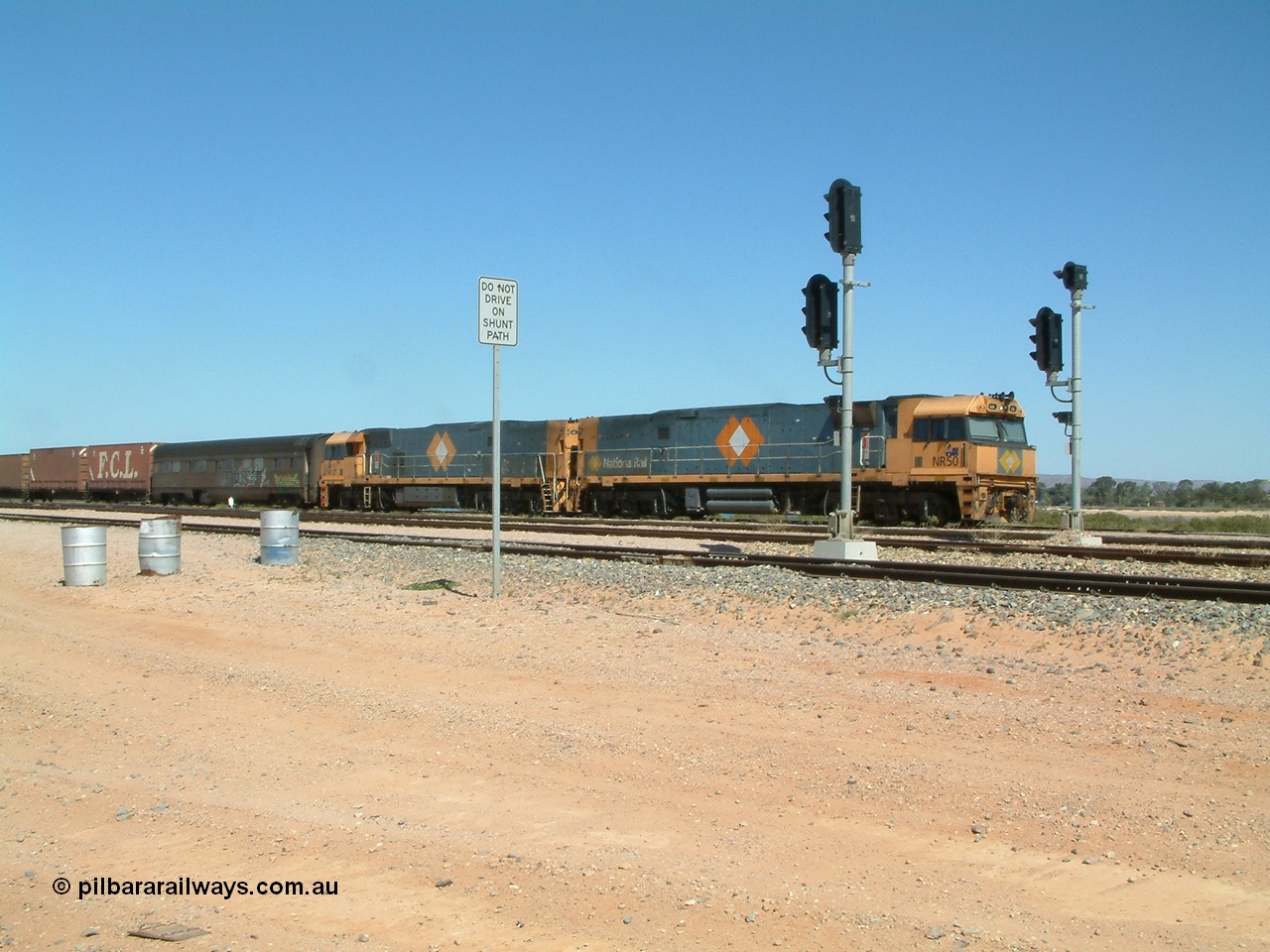 030404 125017
Port Augusta Spencer Junction yard, a Perth bound intermodal awaits departure time on 13 Road behind National Rail NR class units built by Goninan as GE Cv40-9i models, NR 50 serial 7250-08 / 97-252 and NR 37 serial 7250-06 / 97-239. 4th April 2003.
Keywords: NR-class;NR50;Goninan;GE;Cv40-9i;7250-08/97-252;