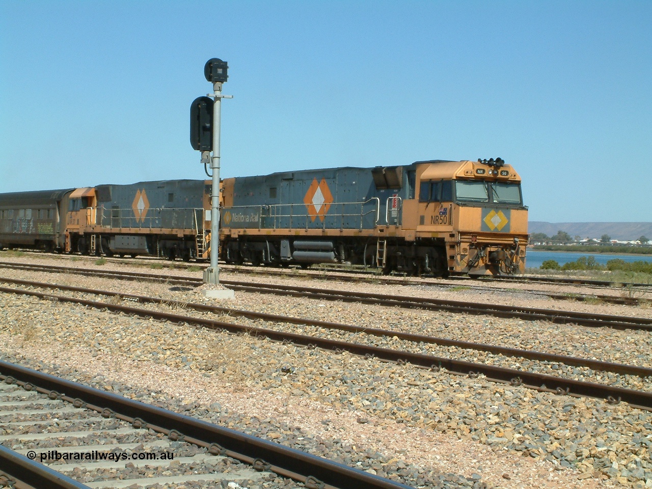 030404 125101
Port Augusta Spencer Junction yard, a Perth bound intermodal awaits departure time on 13 Road behind National Rail NR class units built by Goninan as GE Cv40-9i models, NR 50 serial 7250-08 / 97-252 and NR 37 serial 7250-06 / 97-239. 4th April 2003.
Keywords: NR-class;NR50;Goninan;GE;Cv40-9i;7250-08/97-252;