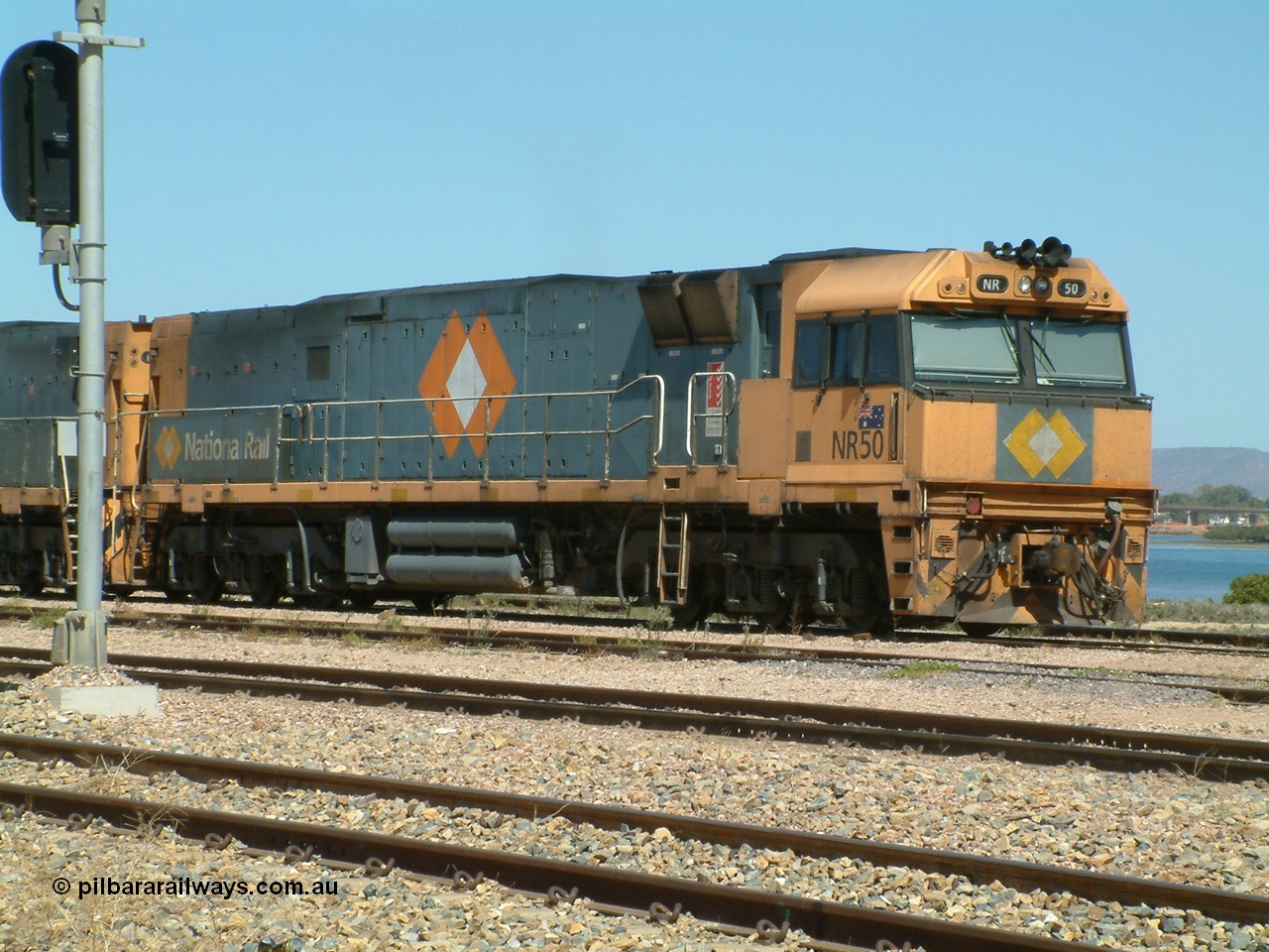 030404 125126
Port Augusta Spencer Junction yard, a Perth bound intermodal awaits departure time on 13 Road behind National Rail NR class units built by Goninan as GE Cv40-9i models, NR 50 serial 7250-08 / 97-252. 4th April 2003.
Keywords: NR-class;NR50;Goninan;GE;Cv40-9i;7250-08/97-252;