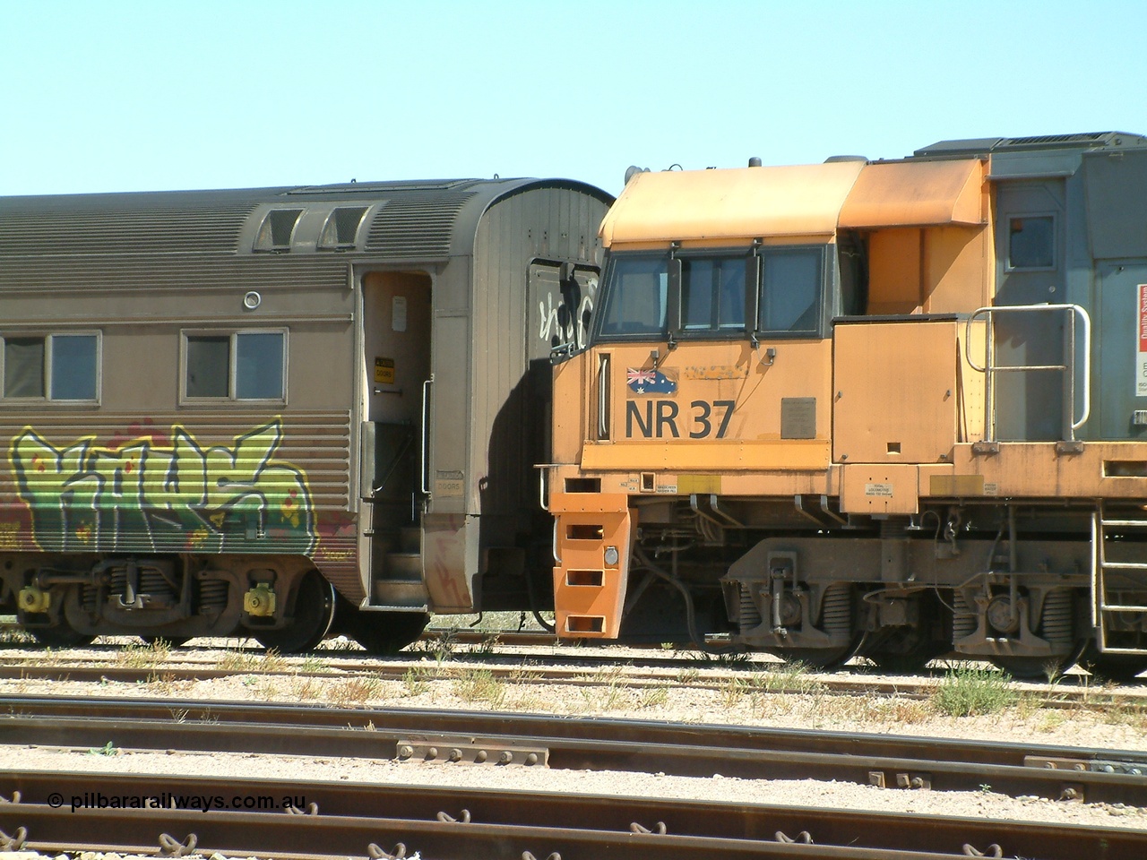 030404 125253
Port Augusta Spencer Junction yard, a Perth bound intermodal awaits departure time on 13 Road behind National Rail NR class unit built by Goninan as GE Cv40-9i models, NR 37 serial 7250-06 / 97-239. 4th April 2003.
Keywords: NR-class;NR37;Goninan;GE;Cv40-9i;7250-06/97-239;