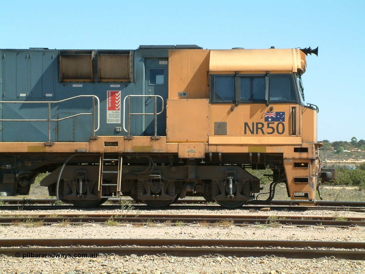 030404 125337
Port Augusta Spencer Junction yard, a Perth bound intermodal awaits departure time on 13 Road behind National Rail NR class units built by Goninan as GE Cv40-9i models, NR 50 serial 7250-08 / 97-252. 4th April 2003.
Keywords: NR-class;NR50;Goninan;GE;Cv40-9i;7250-08/97-252;