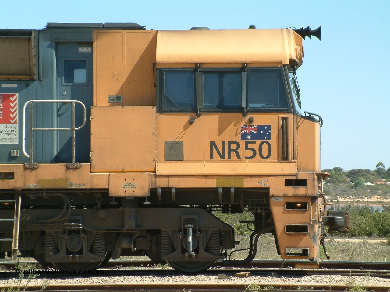 030404 125349
Port Augusta Spencer Junction yard, a Perth bound intermodal awaits departure time on 13 Road behind National Rail NR class units built by Goninan as GE Cv40-9i models, NR 50 serial 7250-08 / 97-252. 4th April 2003.
Keywords: NR-class;NR50;Goninan;GE;Cv40-9i;7250-08/97-252;