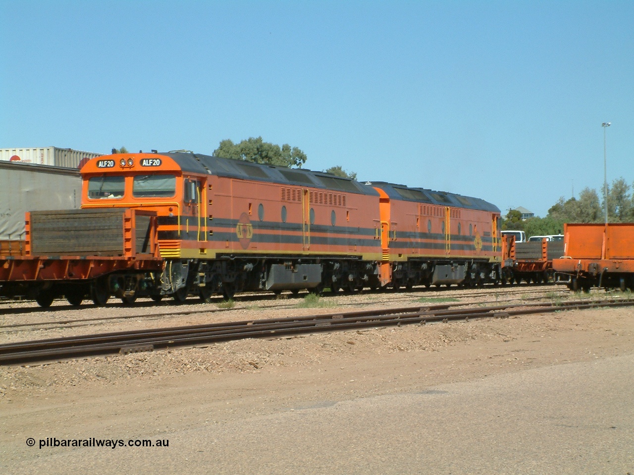 030404 131042
Port Augusta Spencer Junction yard, MKA (Morrison Knudsen Australia) rebuilt AL class AL 24 into EMD JT26C-2M model for Australian National in 1993 as the ALF class, here ALF 20 serial 94-AB-020 shunts empty rail transport waggon sets from the Darwin construction. 4th April, 2003.
Keywords: ALF-class;ALF20;MKA;EMD;JT26C-2M;94-AN-020;rebuild;AL-class;AL24;Clyde-Engineering;EMD;JT26C;76-840;