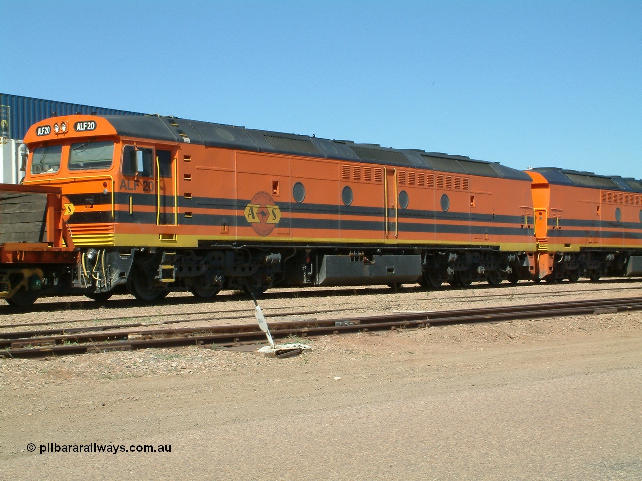 030404 131049
Port Augusta Spencer Junction yard, MKA (Morrison Knudsen Australia) rebuilt AL class AL 24 into EMD JT26C-2M model for Australian National in 1993 as the ALF class, here ALF 20 serial 94-AB-020 shunts empty rail transport waggon sets from the Darwin construction. 4th April, 2003.
Keywords: ALF-class;ALF20;MKA;EMD;JT26C-2M;94-AN-020;rebuild;AL-class;AL24;Clyde-Engineering;EMD;JT26C;76-840;