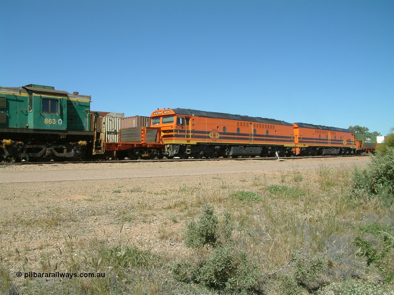 030404 131855
Port Augusta Spencer Junction yard, MKA (Morrison Knudsen Australia) rebuilt AL class AL 24 into EMD JT26C-2M model for Australian National in 1993 as the ALF class, here ALF 20 serial 94-AB-020 shunts empty rail transport waggon sets from the Darwin construction. 4th April, 2003.
Keywords: ALF-class;ALF20;MKA;EMD;JT26C-2M;94-AN-020;rebuild;AL-class;AL24;Clyde-Engineering;EMD;JT26C;76-840;