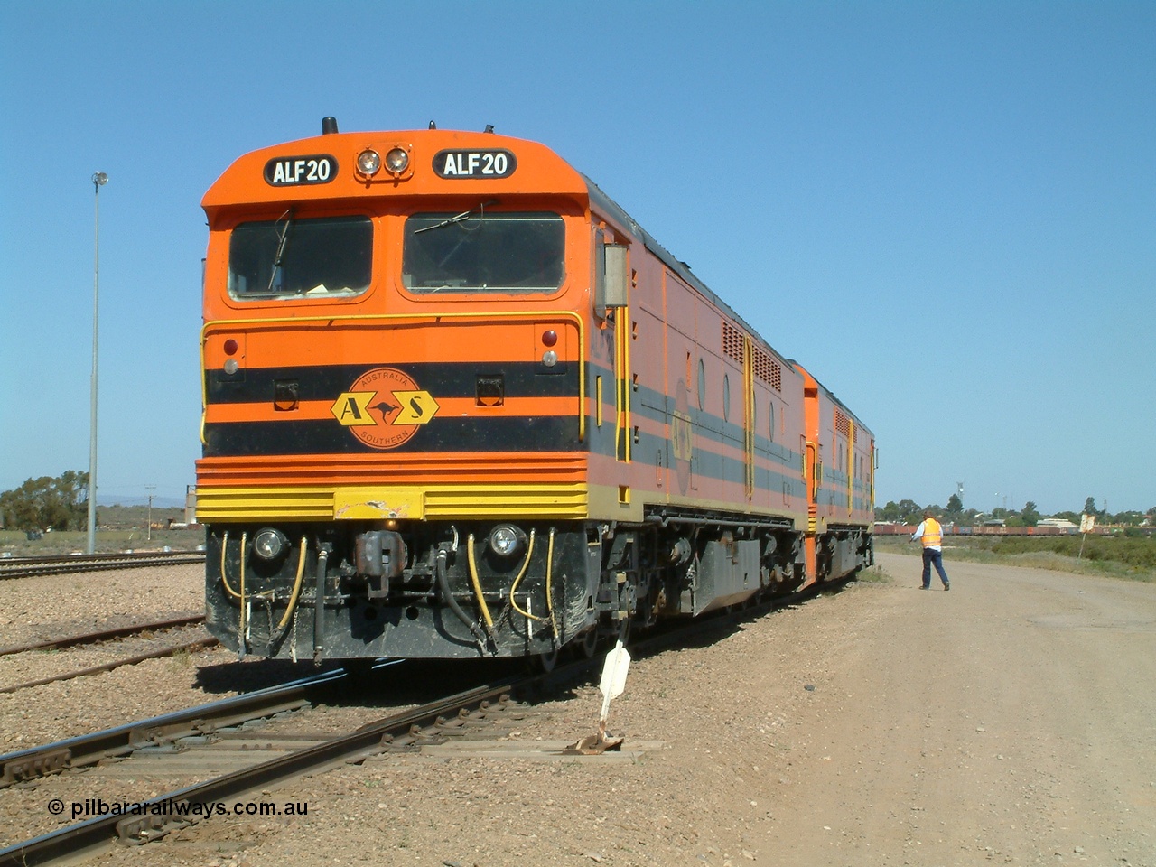 030404 141115
Port Augusta Spencer Junction yard, MKA (Morrison Knudsen Australia) rebuilt AL class AL 24 into EMD JT26C-2M model for Australian National in 1993 as the ALF class, here ALF 20 serial 94-AB-020 shunts empty rail transport waggon sets from the Darwin construction. 4th April, 2003.
Keywords: ALF-class;ALF20;MKA;EMD;JT26C-2M;94-AN-020;rebuild;AL-class;AL24;Clyde-Engineering;EMD;JT26C;76-840;