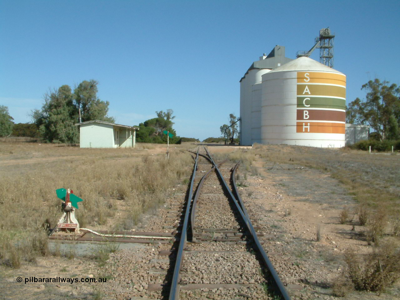030405 145520
Warramboo, yard overview looking south with siding point levers and indicators, station building on left and Ascom style silo complex in front of concrete SACBH silo complex, 5th April 2003.
