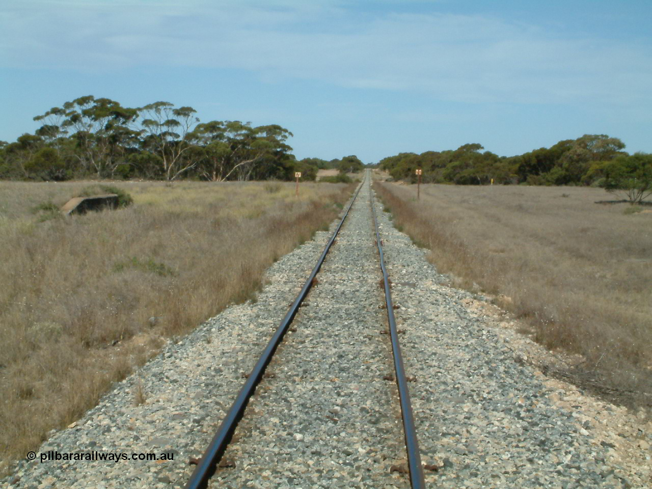 030405 153114
McLachlan, station located at the 156 km, originally opened in September 1914 and called 97 Miles till 1915, closed in August 1972, view looking south with remains of loading ramp at left and square W boards for 'whistle', 5th April 2003.
