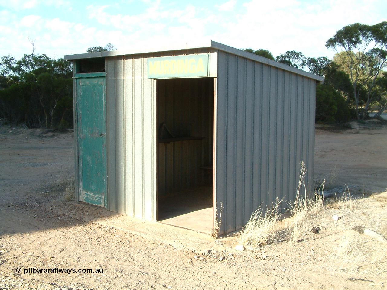 030406 082550
Murdinga, station located at the 128.2 km, originally opened December 1935 and originally referred to as Corunna, train control cabin and waiting room - shelter with station name board, 6th April 2003.
