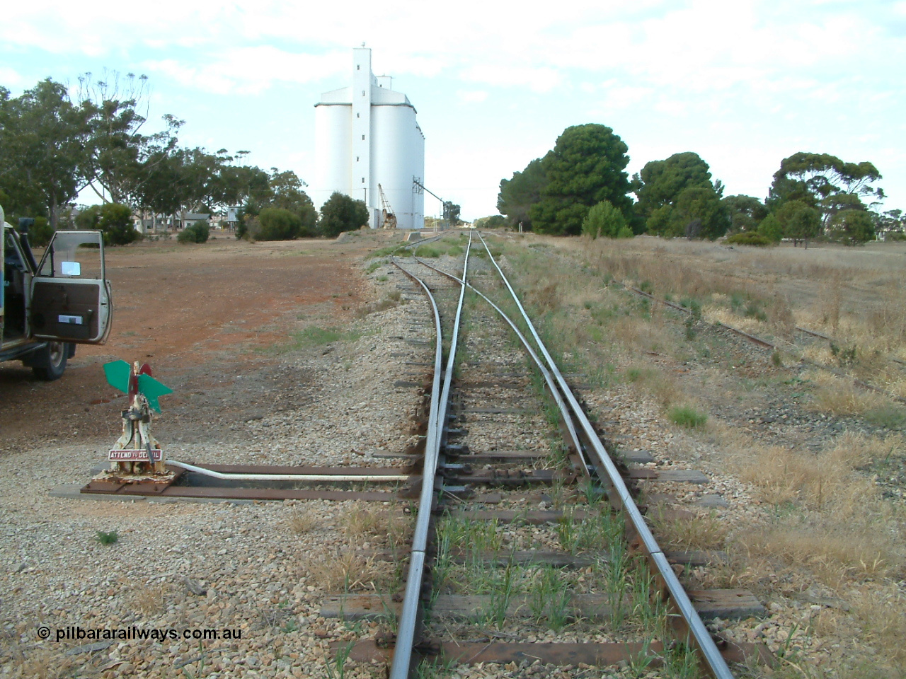 030406 091403
Yeelanna, yard overview looking south from the goods siding north end points, leaver and indicator, goods ramp with crane and concrete silo complex. 6th April 2003.
